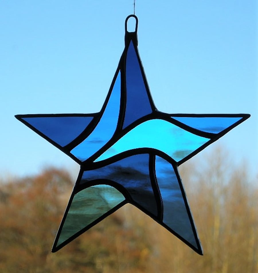 Stained Glass Star (Abstract) in three different blues rippling water glass
