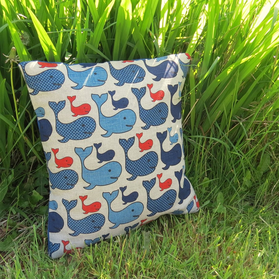 A nautical cushion, complete with feather pad.  Whales.  Nursery decor.
