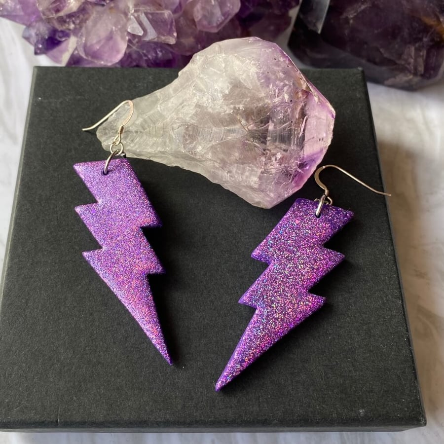 Purple lightning bolt glitter polymer clay and resin statement earrings.