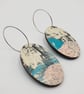 Oval shaped earrings in a watery effect print, blues, white, grey and pink - Image 1