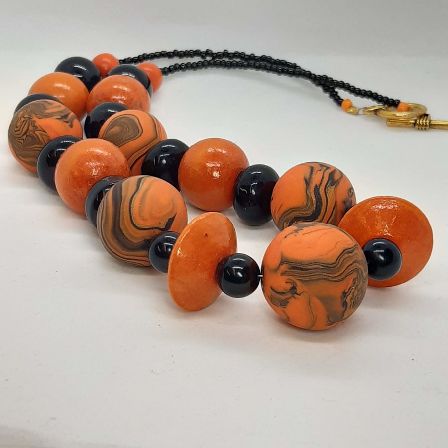 Chunky orange and black polymer clay necklace