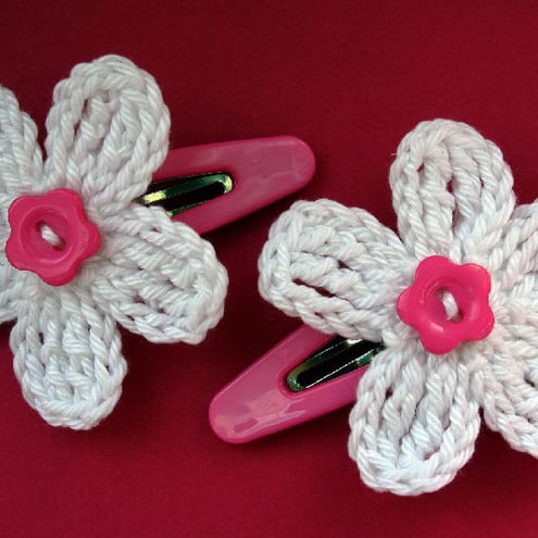 A pair of hair clips with crochet WHITE flowers/PINK buttons