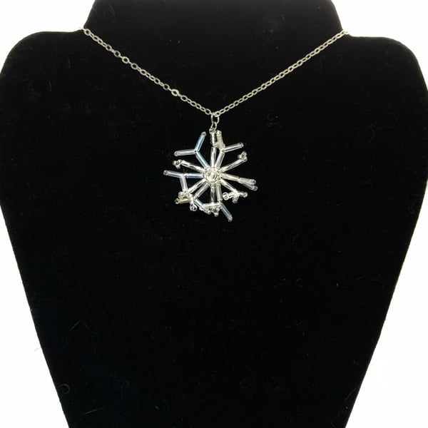 Silver and white beaded snowflake pendant necklace on trace silver chain