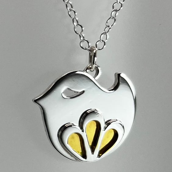 Sterling silver bird pendant with flower motif and gold enamel detail