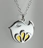 Sterling silver bird pendant with petal embellishment and gold enamel detail