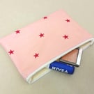 Make up bag in pink oilcloth with stars, cream lining, handmade