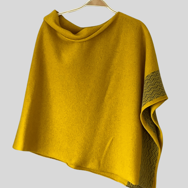 Soft merino lambswool piccalilli yellow poncho with wavy uniform grey border