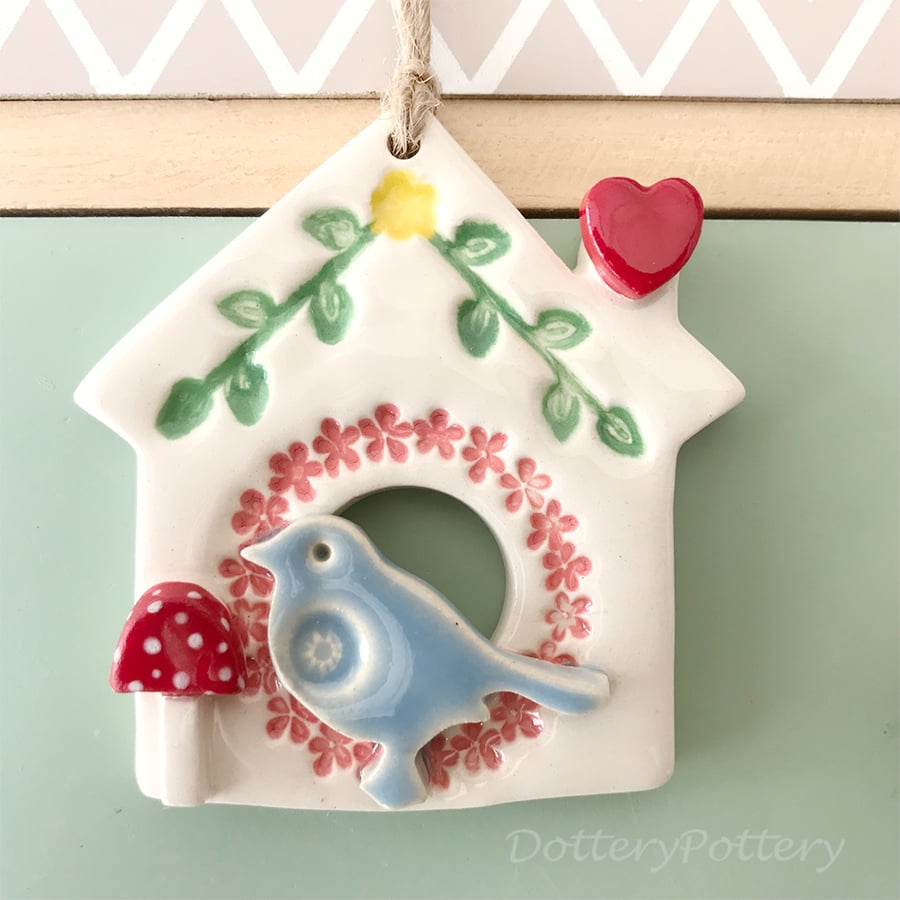 Small Ceramic bird house decoration with pink wreath and toadstool