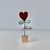 A Valentine Flower with a Wire Stem and Wooden Block Stand