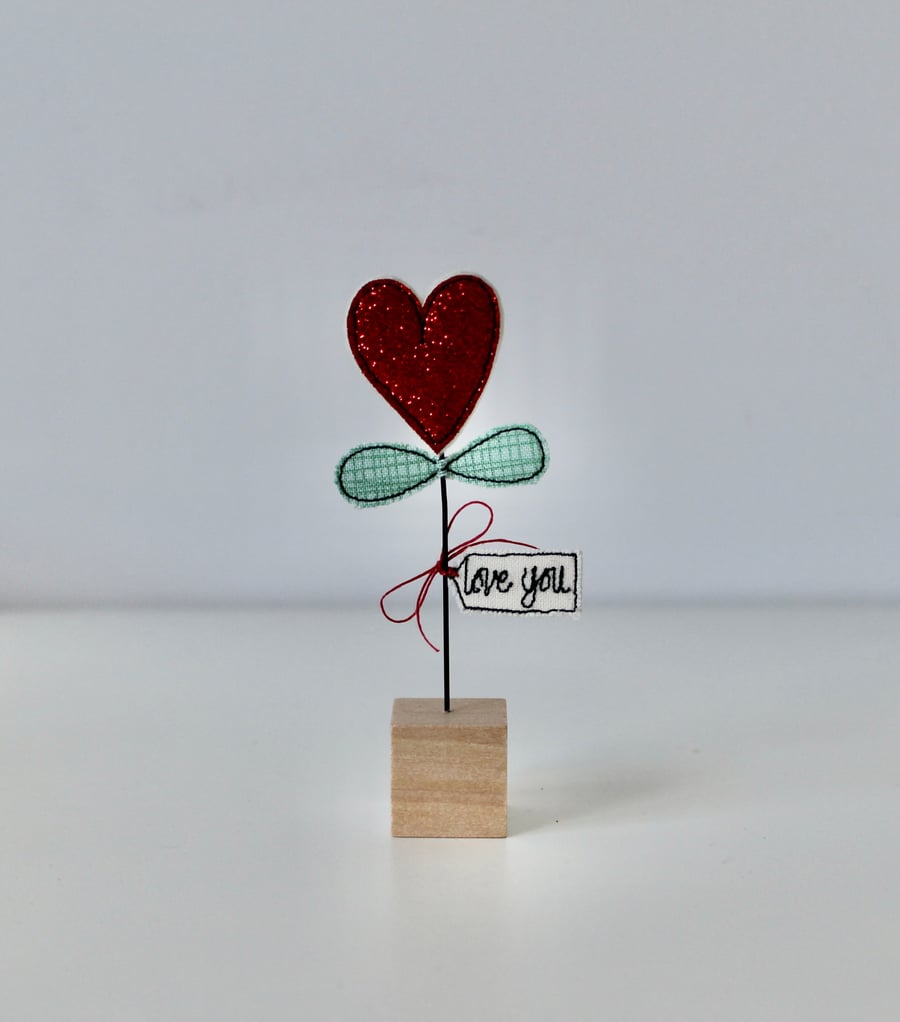 A Heart Flower with a Wire Stem and Wooden Block Stand