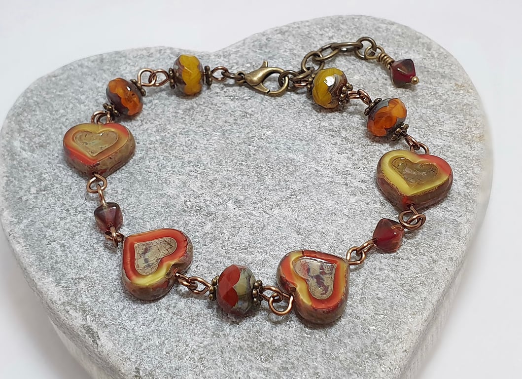 Rustic heart bracelet in red and dark yellow tones