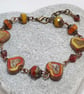 Rustic heart bracelet in red and dark yellow tones - Image 1