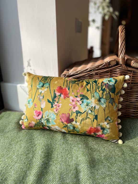 Yellow floral velvet cushion cover with blush pink cotton back and pompoms