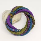 Felted cord bracelet in shades of purple, olive and blue