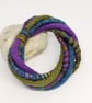 Felted cord bracelet in shades of purple, olive and blue