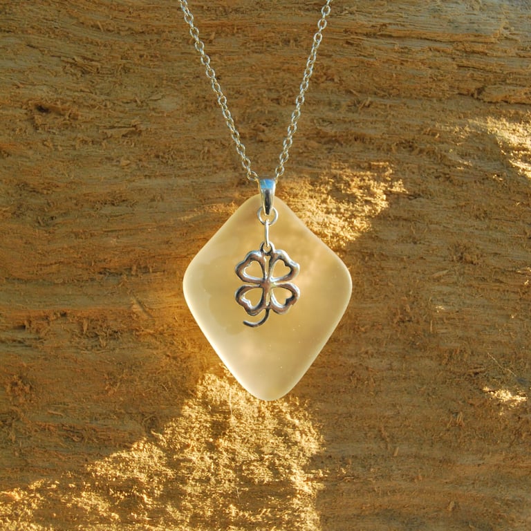 Beach glass pendant with lucky charm