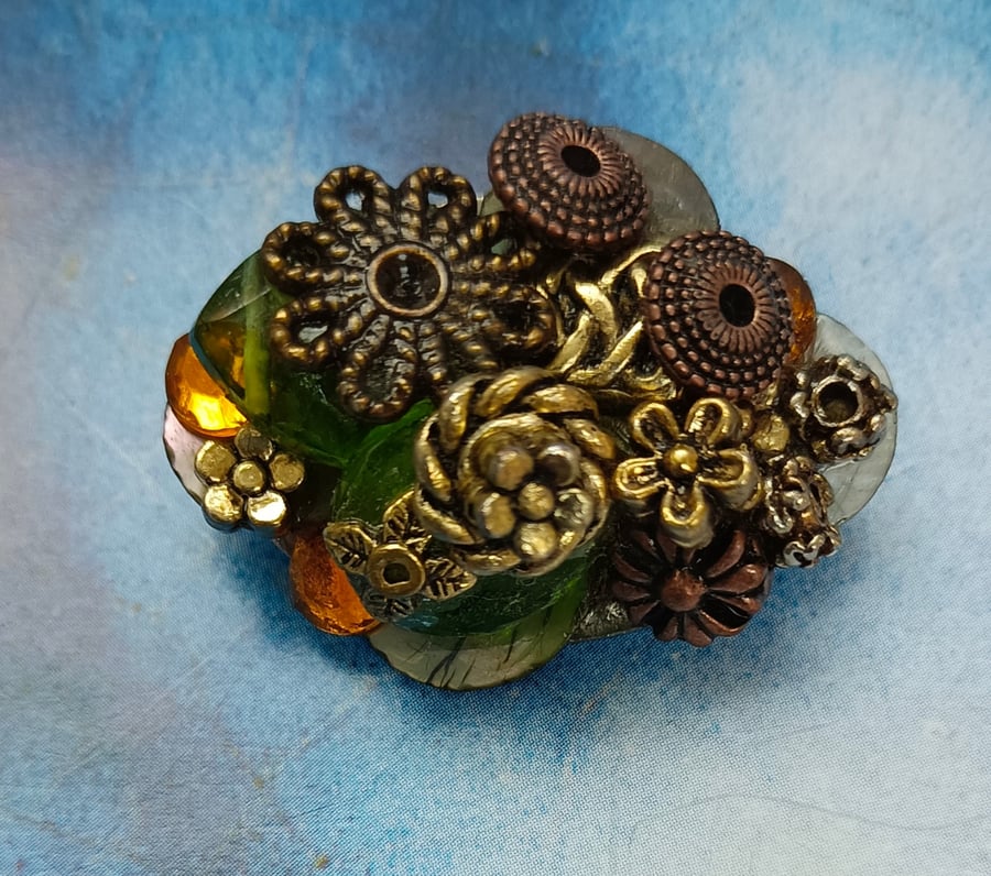 A Bejewelled Brooch with Antique Bronze, Gold, Shell and Crystal Gems