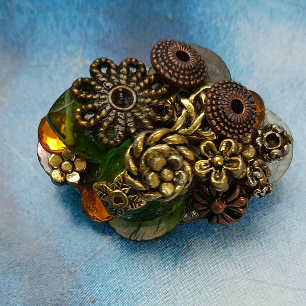 A Bejewelled Brooch with Antique Bronze, Gold, Shell and Crystal Gems