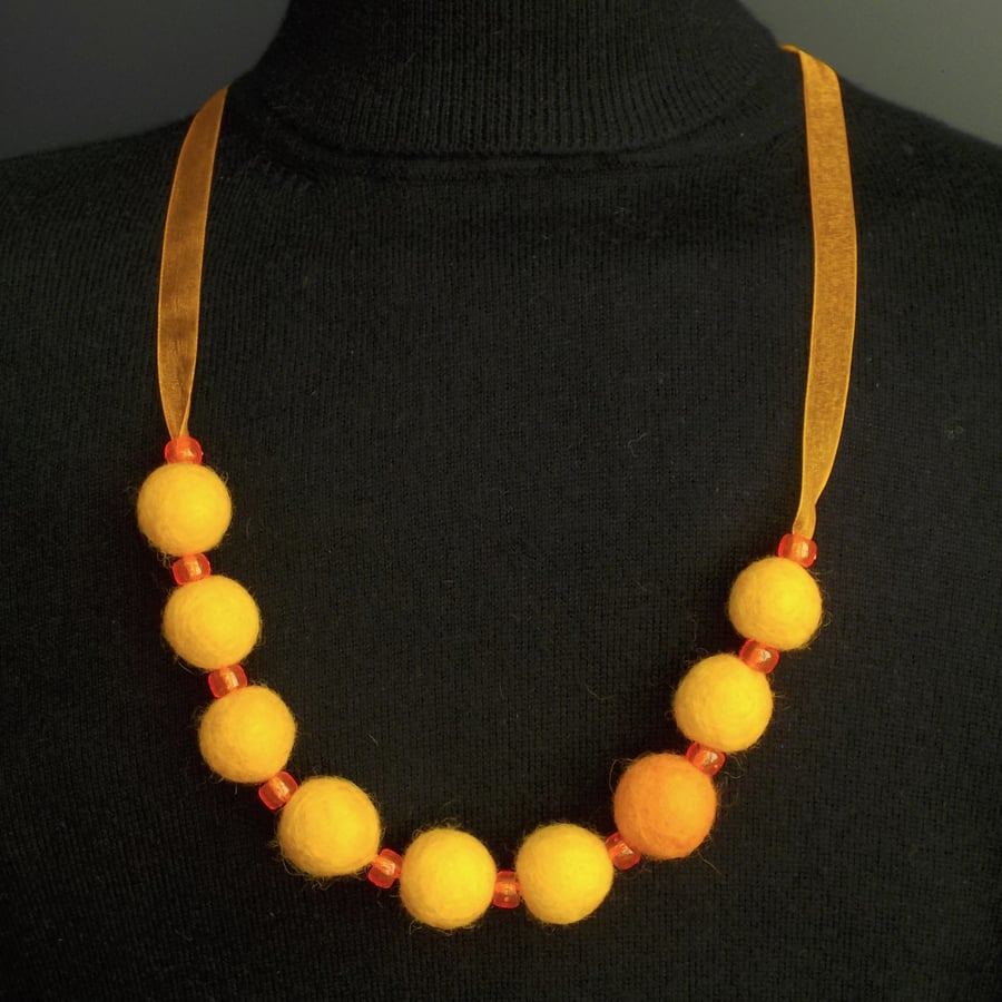 Handmade felt necklace orange beads in gift box.