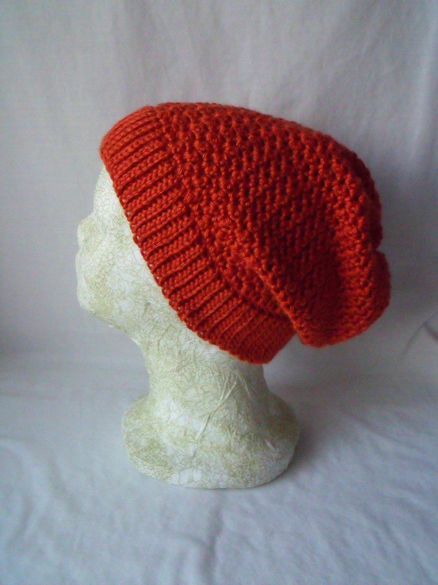 burnt orange coloured crocheted ladies slouch beanie hat