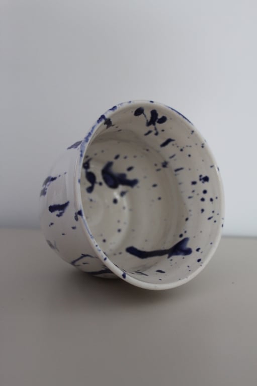 White bowl with blue paint splatter