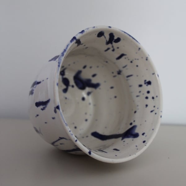 White bowl with blue paint splatter