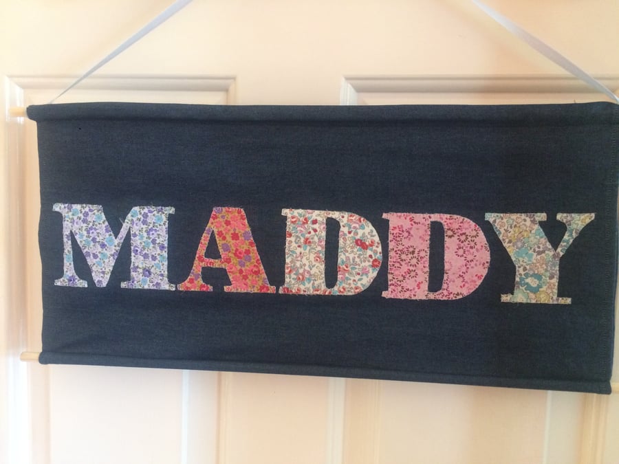 Personalised hanging name banner with hand-stitched lettering