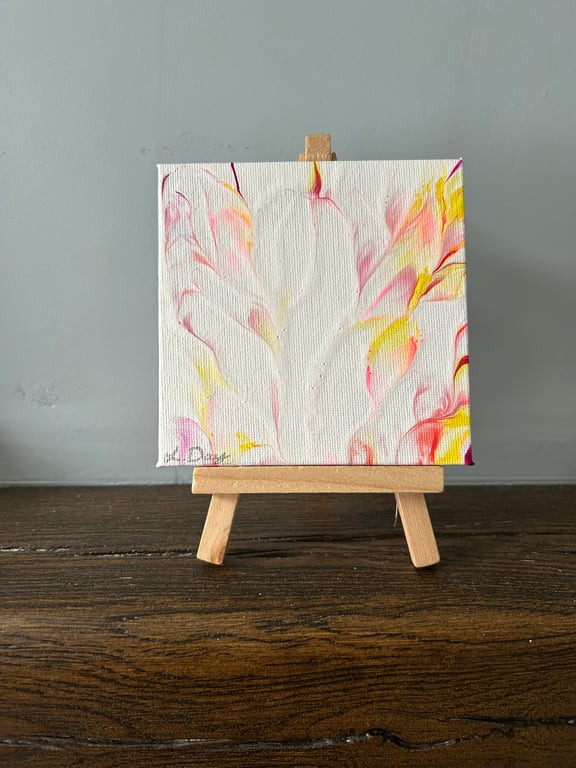 Easel mounted acrylic painted canvas in pinks