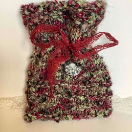 Hand knitted gift bag with grey swirly button