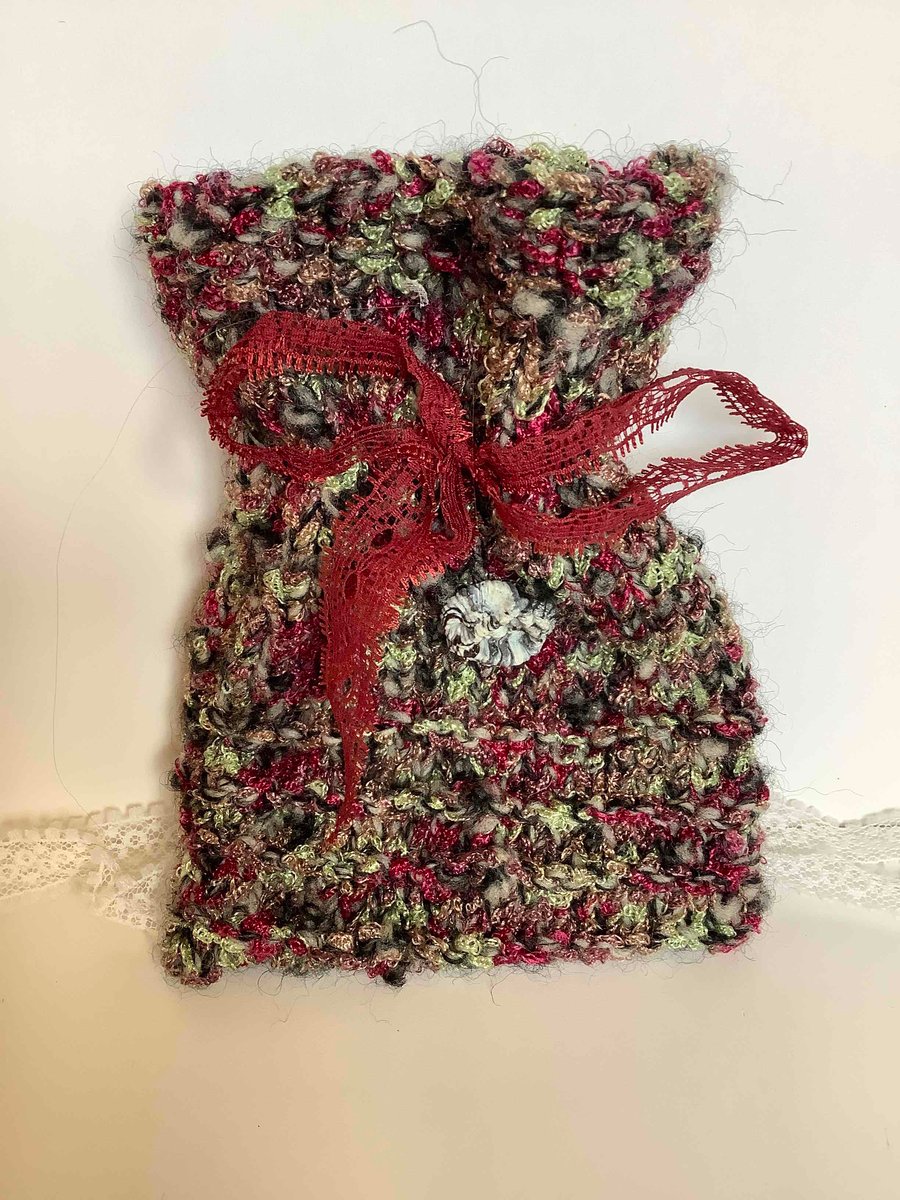 Hand knitted gift bag with grey swirly button