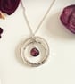 Double circle pendant with ruby garnet