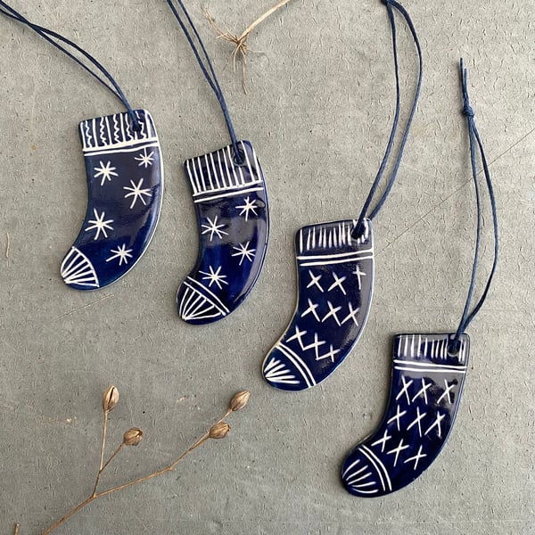 Set of four ceramic sock decorations .