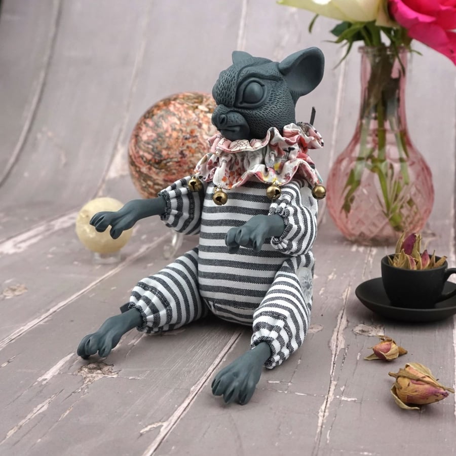 'Teon', a porcelain and textile mouse doll.
