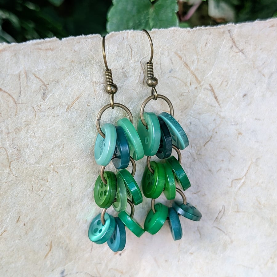 Green button chandelier style earrings with antique gold coloured ear wires 
