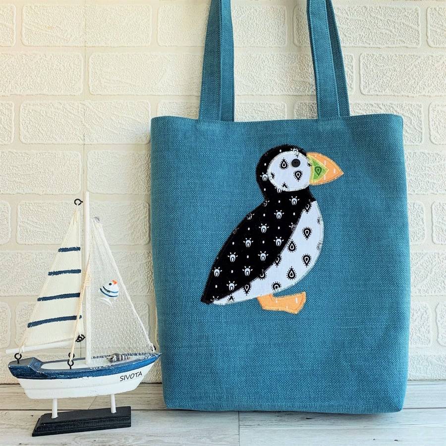 Puffin tote bag in turquoise with black and white patterned puffin