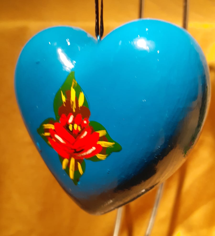 Bright blue heart shaped bauble with canal art style roses