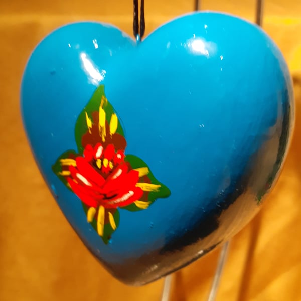 Bright blue heart shaped bauble with canal art style roses