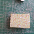 A7 mini sketchbook with budget watercolour paper and open spine 