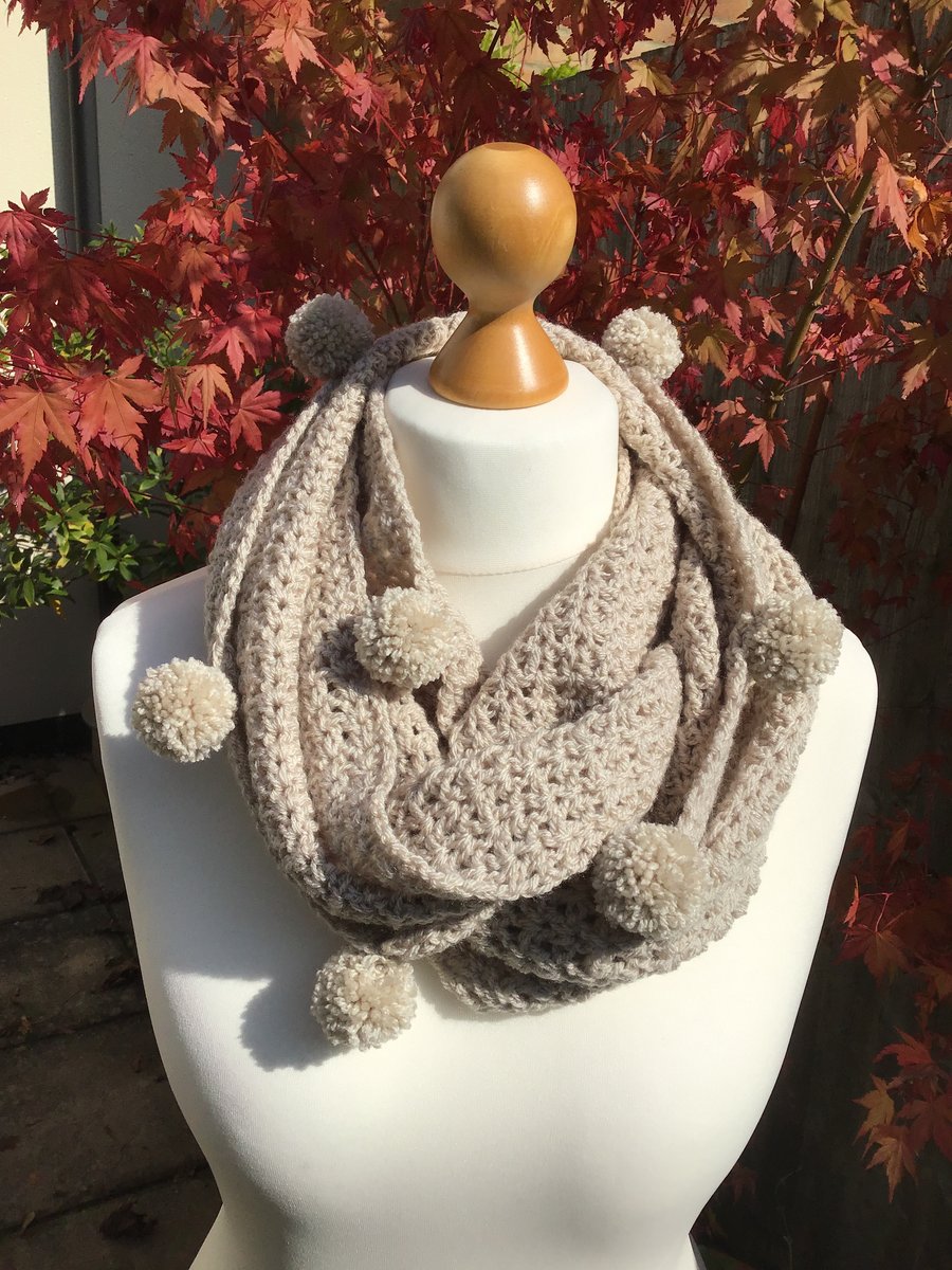 Infinity scarf in acrylic, colour Parchment with matching pom poms.