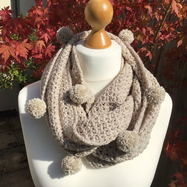 Infinity scarf in acrylic, colour Parchment with matching pom poms.