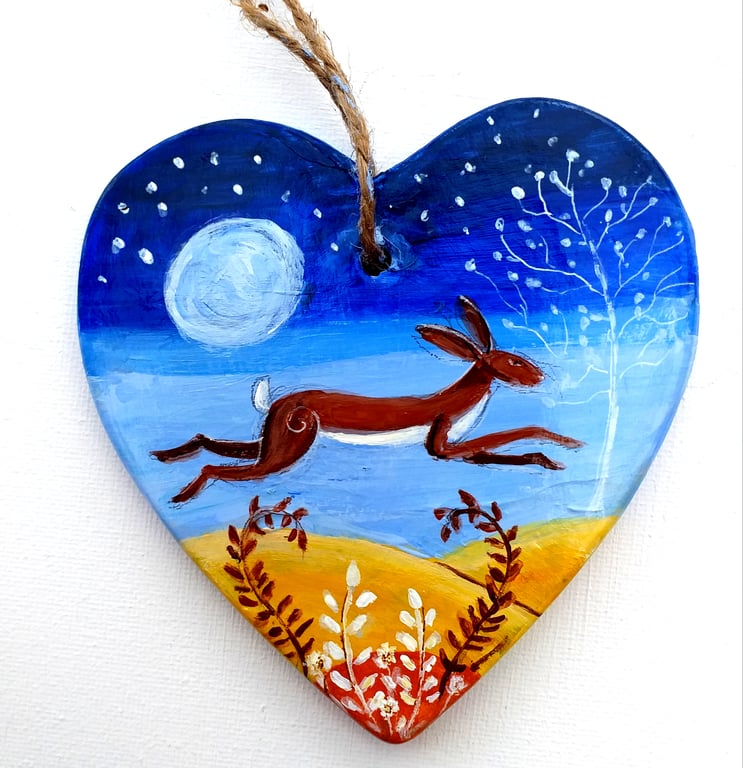 brown hare leaping in moonlight on a ceramic heart 