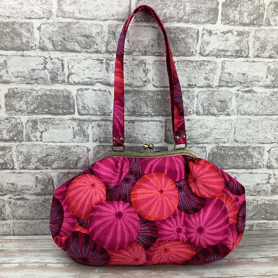 Handbag with discount shells on strap