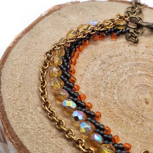 Firey orange, black and gold bead and chain bracelet