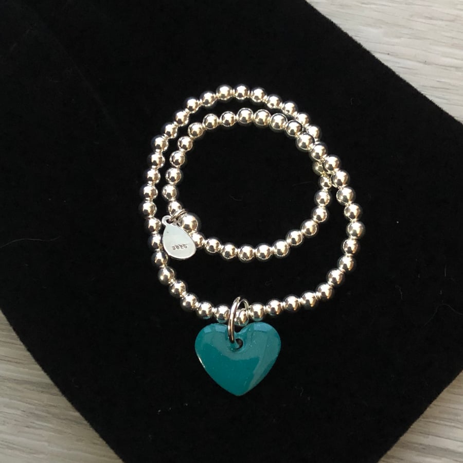 Turquoise enamel heart on silver beaded stretch bracelet. Stacking bracelet.
