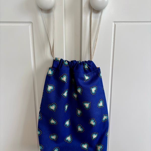 Blue cotton drawstring bag with jade and white hearts, with linen style ribbon.