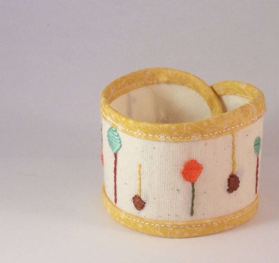 Hand embroidered textile jewellery - fabric cuff with button fastening