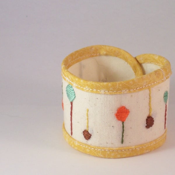 Hand embroidered textile jewellery - fabric cuff with button fastening