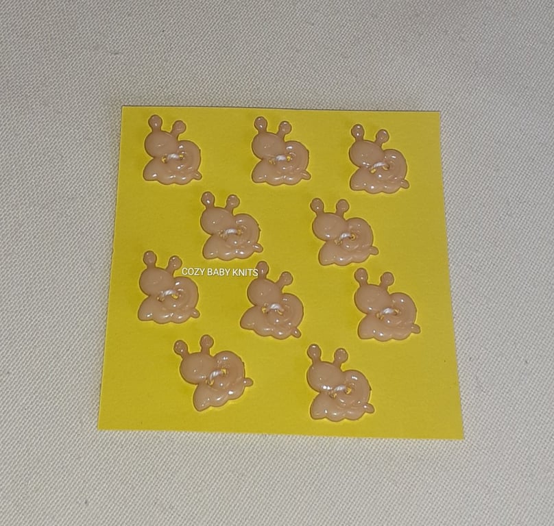 BEIGE SNAIL SHAPED BUTTONS WITH TWO HOLES FOR ATTACHING 