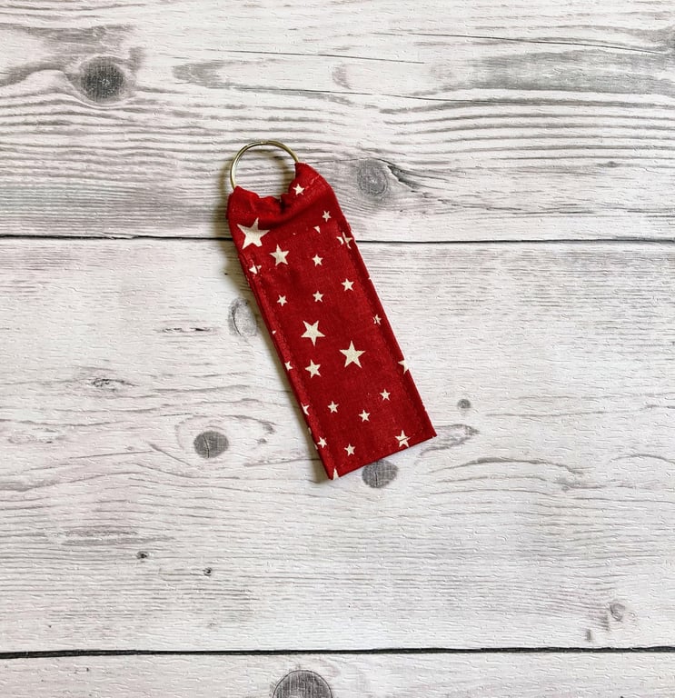 Red with white stars themed fun lip balm cotton fabric keyring.