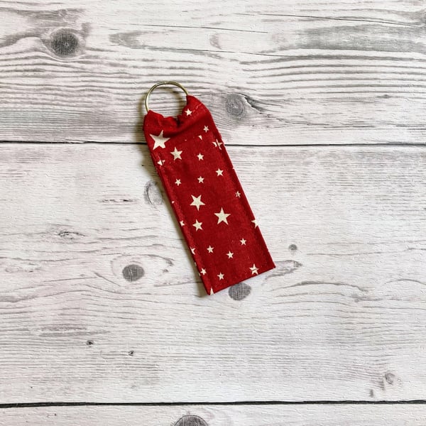 Red with white stars themed fun lip balm cotton fabric keyring.